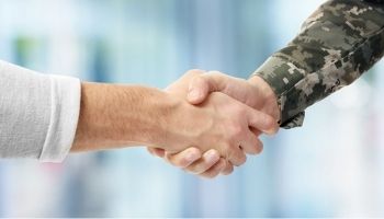 Veteran and construction manager shaking hands